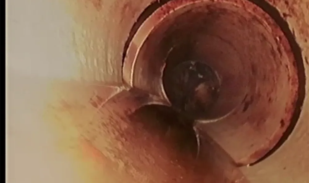 In-pipe camera view of a sewer pipe joint that has separated, showing a visible offset between two pipe sections